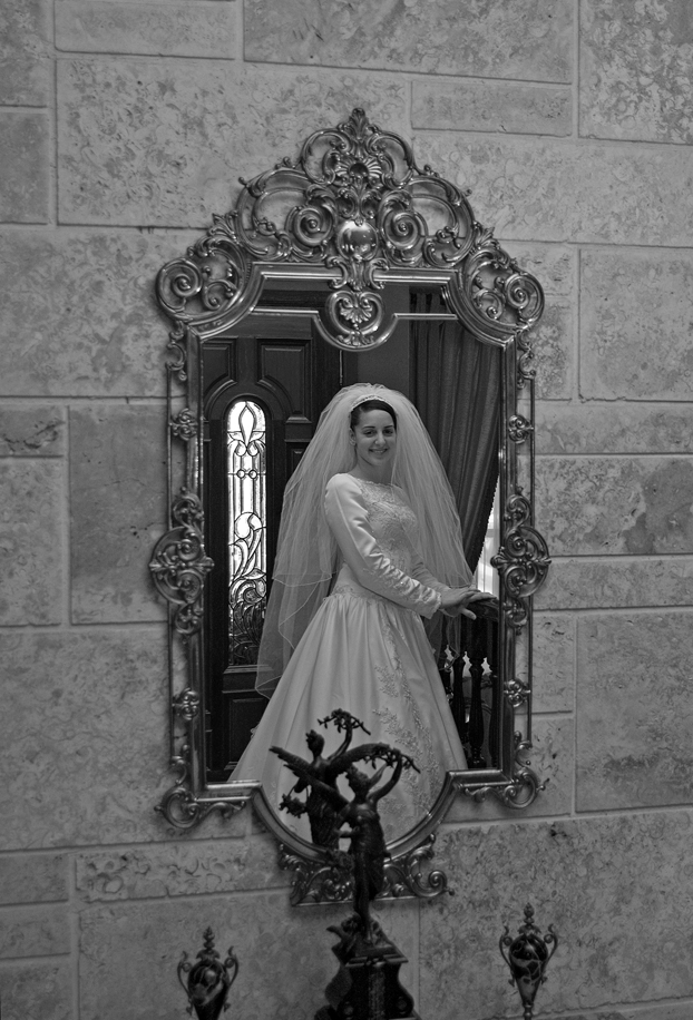 Beautiful Wedding Bride Looking at herself in a mirror in miami Beautiful Wedding Bride Looking at herself in a mirror in miami